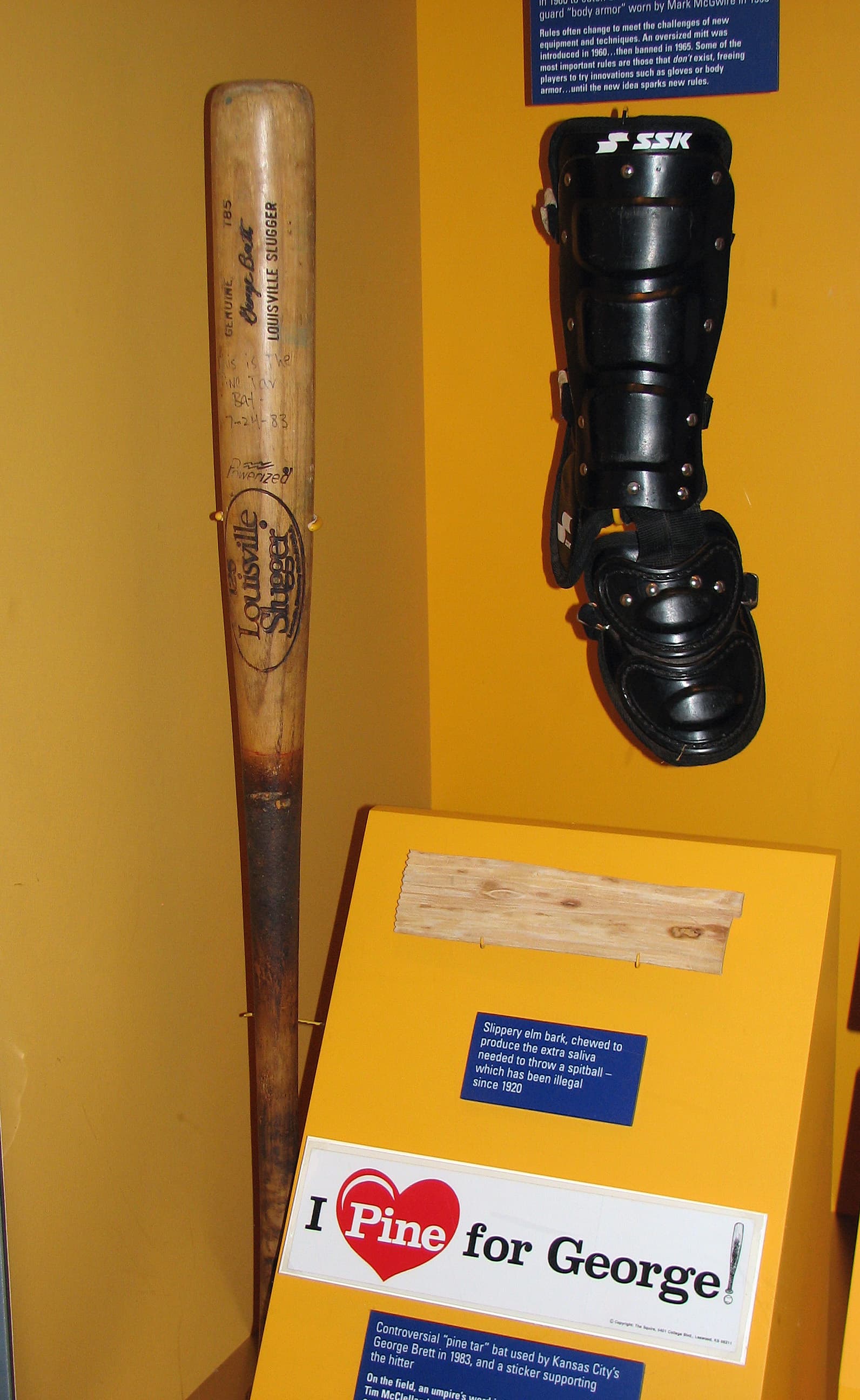 George Brett's pine-tar bat on display at the Henry Ford Museum in 2006, beside Mark McGwire's body armor. The photograph is of the bat years later, not the July 24, 1983 at-bat.